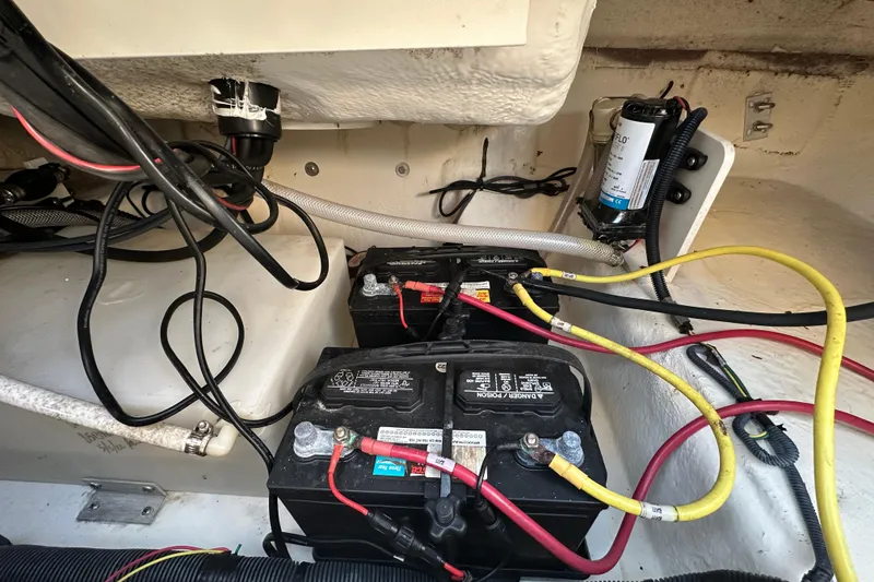 Slide: The Image of 2023 Robalo R222 Center Console boat electrical compartment with wiring and control panel. - 64