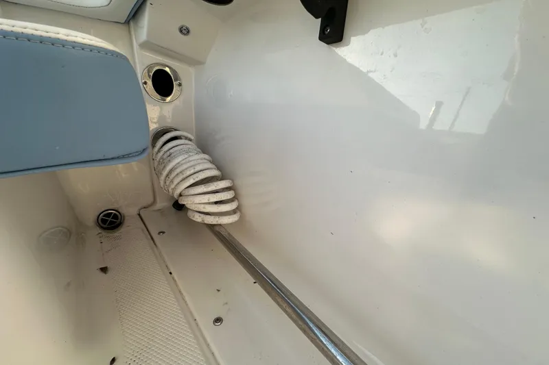 Slide: The Image of 2023 Robalo R222 Center Console boat interior with storage compartment and rod holders. - 68