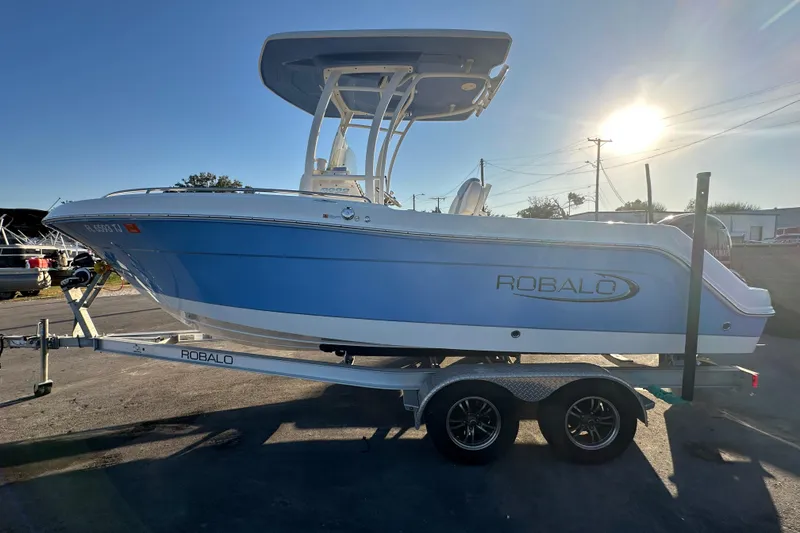 Slide: The Image of 2023 Robalo R222 Center Console boat with powerful 200 HP engine on trailer. - 8