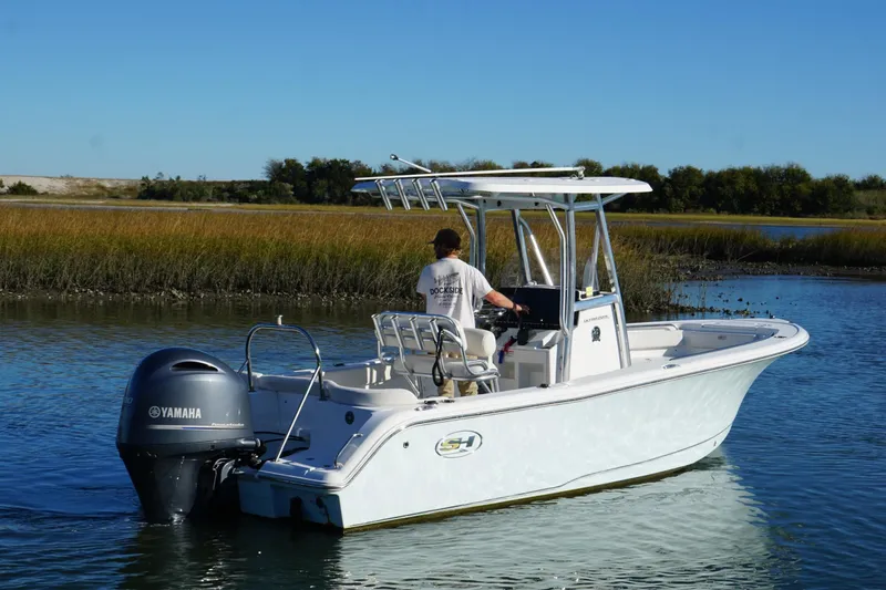 Slide: The Image of 2021 Sea Hunt Ultra 229 boat with Yamaha engine on calm water. - 5