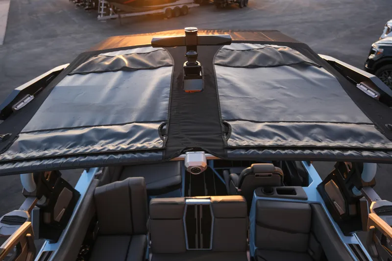 Slide: The Image of 2024 Supra SL boat with retractable canopy and luxurious seating. - 24