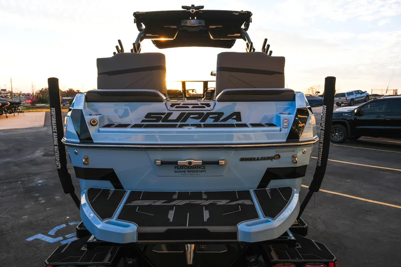 Slide: The Image of 2024 Supra SL boat rear view at sunset in parking lot. - 4