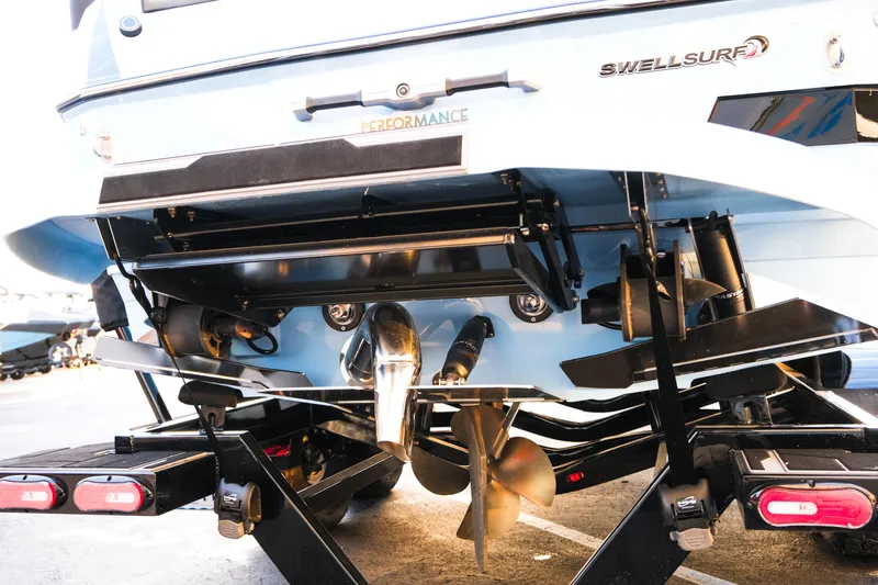 Slide: The Image of 2024 Supra SL boat rear view showcasing propeller and Swell Surf system. - 5