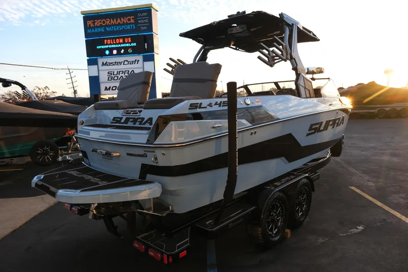 Slide: The Image of 2024 Supra SL boat at a dealership, showcasing sleek design and modern features. - 6