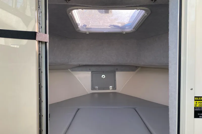 Slide: The Image of 2023 Defiance Admiral 250 EX cabin interior with skylight and storage compartment. - 5