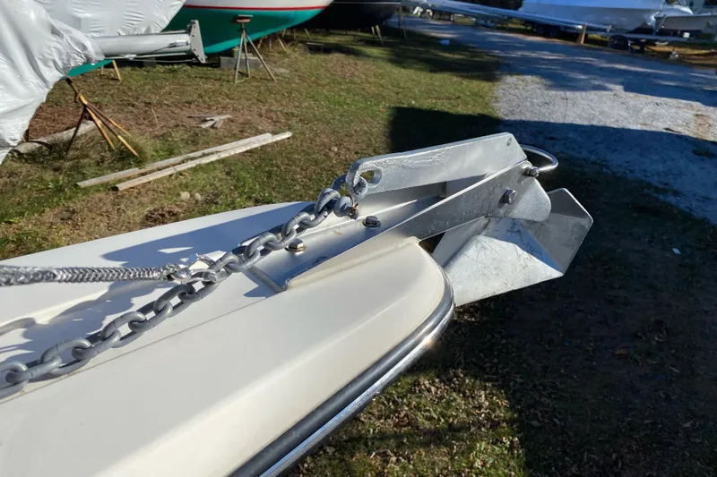 Slide: The Image of 2023 Defiance Admiral 250 EX boat anchor and chain on deck, outdoor setting. - 8