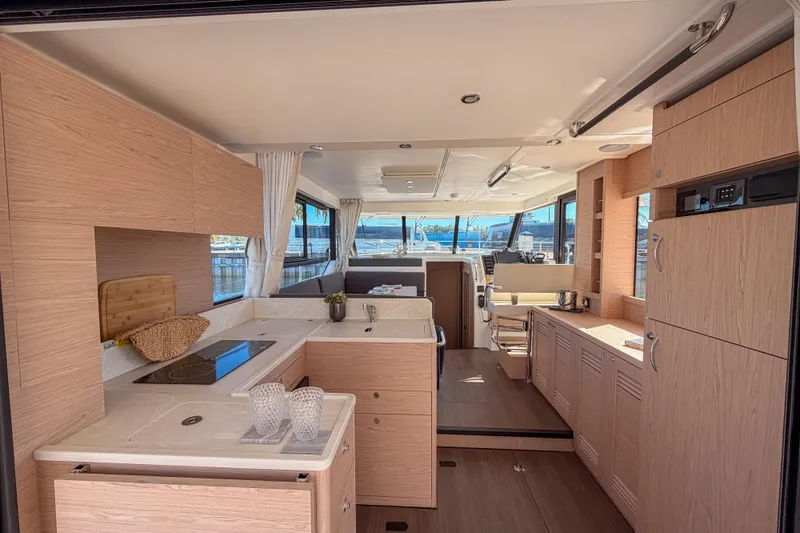 Slide: The Image of Interior of 2026 Beneteau Swift Trawler 41 Fly, modern kitchen and helm area. - 17
