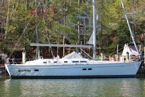 The Image of 2003 Beneteau Oceanis 42CC sailboat docked in a serene, wooded marina. - 0