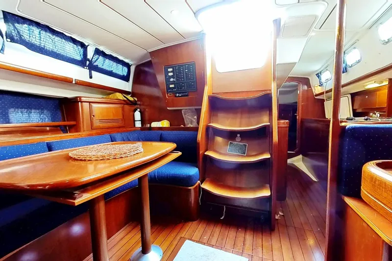 Slide: The Image of Interior of 2003 Beneteau Oceanis 42CC sailboat with wooden furnishings and seating area. - 10