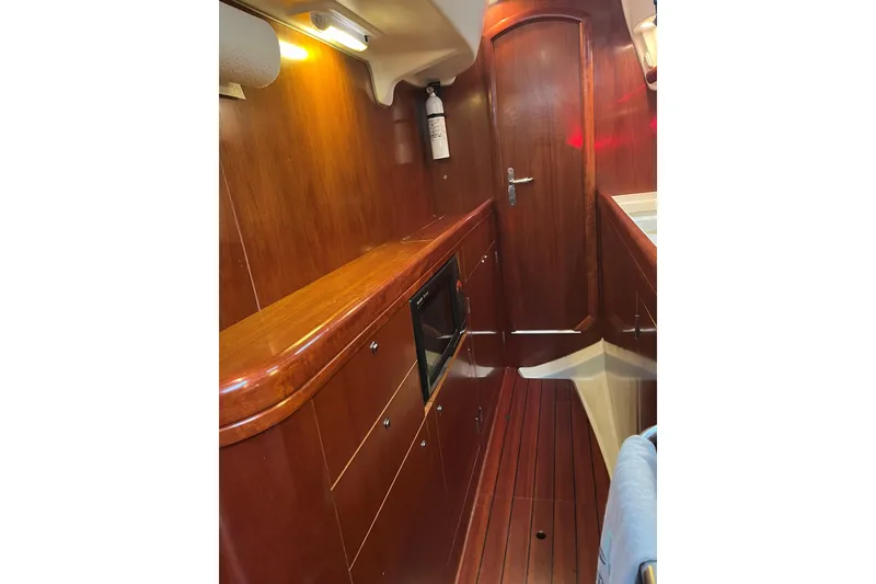 Slide: The Image of Interior of 2003 Beneteau Oceanis 42CC yacht with wooden cabinetry and flooring. - 13