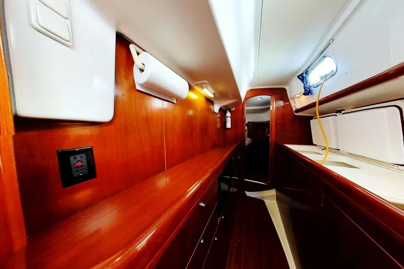 Slide: The Image of Interior of 2003 Beneteau Oceanis 42CC yacht with wooden cabinetry and modern amenities. - 14