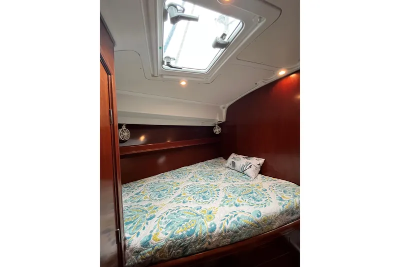Slide: The Image of Cozy cabin interior of 2003 Beneteau Oceanis 42CC with skylight and patterned bedding. - 23
