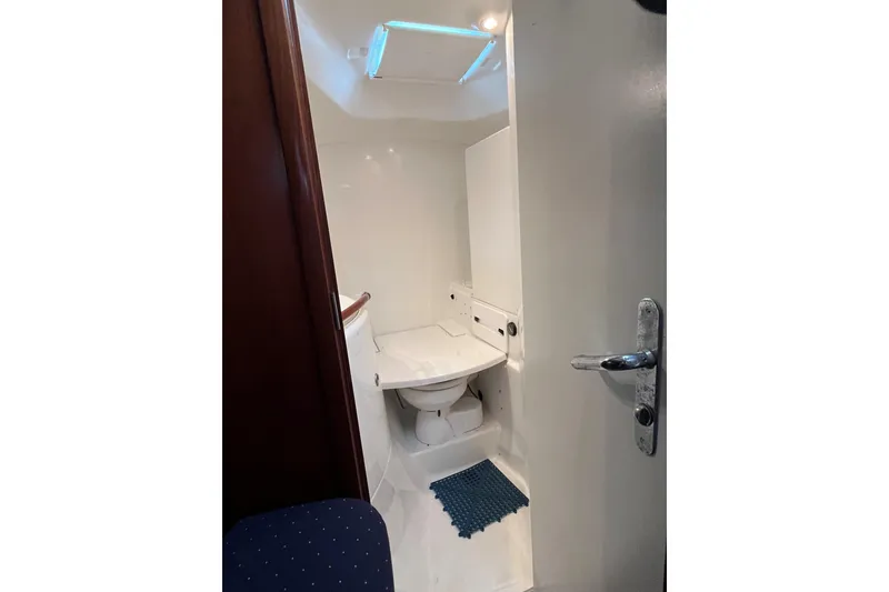 Slide: The Image of Bathroom interior of 2003 Beneteau Oceanis 42CC yacht, featuring compact design and skylight. - 25