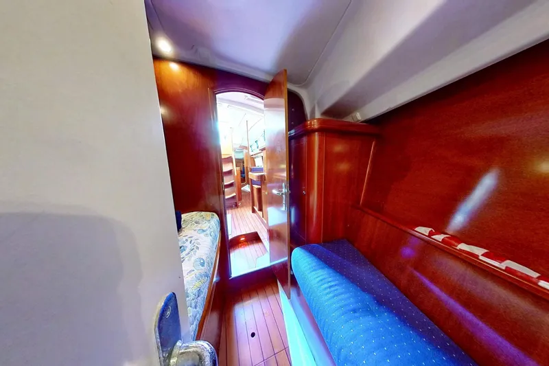 Slide: The Image of Interior of 2003 Beneteau Oceanis 42CC yacht with wooden finish and cozy seating. - 26