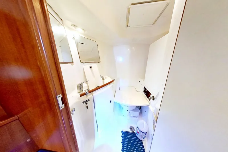 Slide: The Image of Bathroom interior of 2003 Beneteau Oceanis 42CC yacht, featuring sink and toilet. - 27