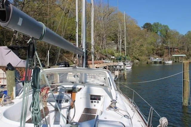 Slide: The Image of 2003 Beneteau Oceanis 42CC sailboat docked in a serene marina setting. - 3