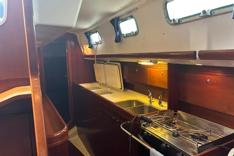 Slide: The Image of Interior of 2003 Beneteau Oceanis 42CC yacht, featuring a well-equipped kitchen area. - 33