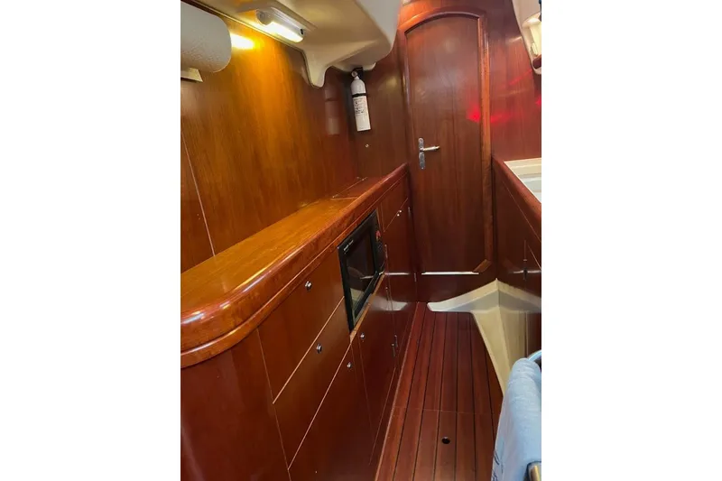 Slide: The Image of Interior of 2003 Beneteau Oceanis 42CC yacht with wooden cabinetry and flooring. - 35