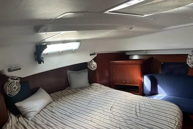 Slide: The Image of Cozy cabin interior of 2003 Beneteau Oceanis 42CC sailboat with bed and seating area. - 45