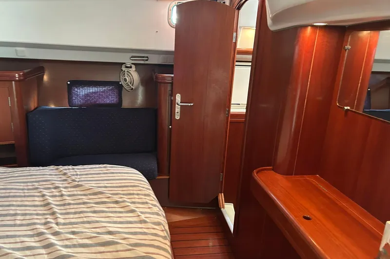 Slide: The Image of Interior of 2003 Beneteau Oceanis 42CC yacht with wood finish and cozy seating. - 49