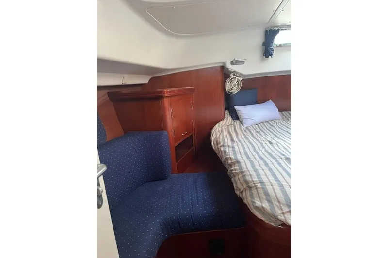 Slide: The Image of Interior of 2003 Beneteau Oceanis 42CC yacht with cozy bed and seating area. - 51