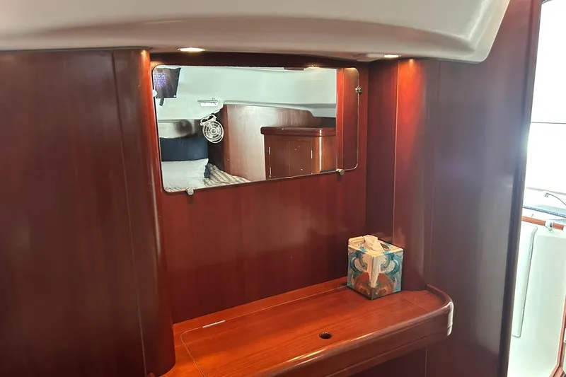 Slide: The Image of Interior of 2003 Beneteau Oceanis 42CC yacht with wooden cabinetry and mirror. - 52
