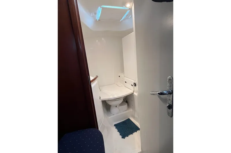 Slide: The Image of Bathroom interior of 2003 Beneteau Oceanis 42CC yacht, featuring a compact toilet. - 59