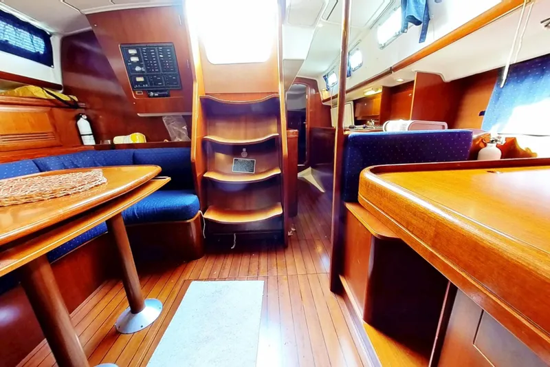 Slide: The Image of Interior of 2003 Beneteau Oceanis 42CC sailboat with wooden furnishings and seating area. - 6