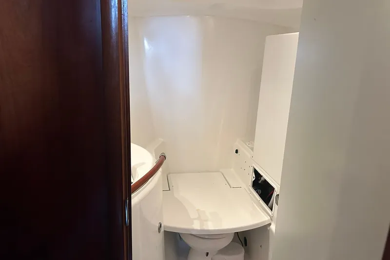 Slide: The Image of Bathroom interior of 2003 Beneteau Oceanis 42CC sailboat, featuring compact design and white fixtures. - 60