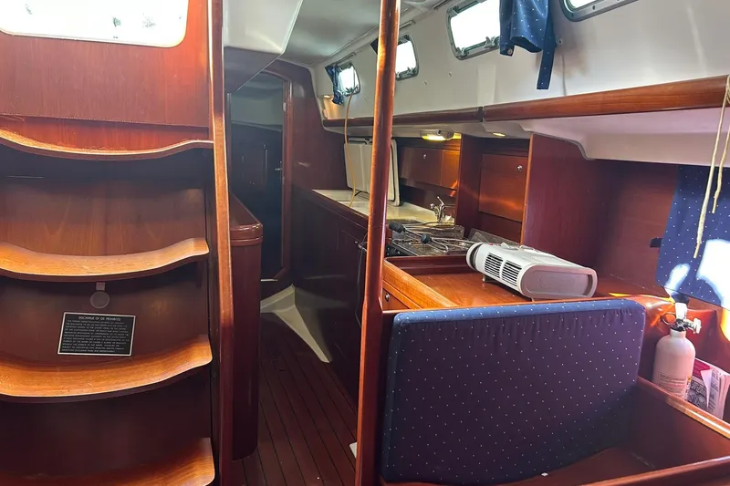 Slide: The Image of Interior of 2003 Beneteau Oceanis 42CC sailboat with wooden cabinetry and compact kitchen. - 62