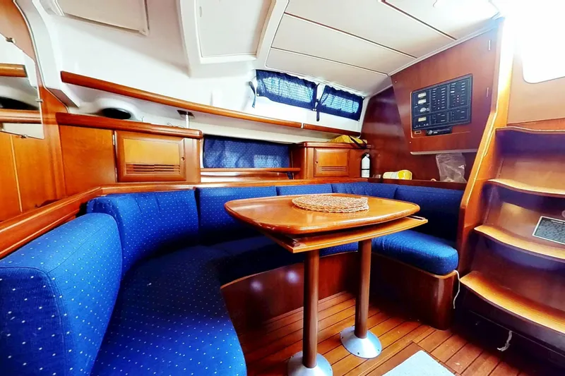 Slide: The Image of Interior of 2003 Beneteau Oceanis 42CC yacht with blue seating and wooden finishes. - 7
