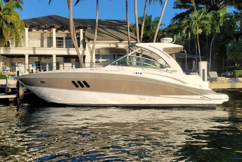 The Image of 2014 Cruisers Yachts 380 Express docked near a luxurious waterfront home. - 0