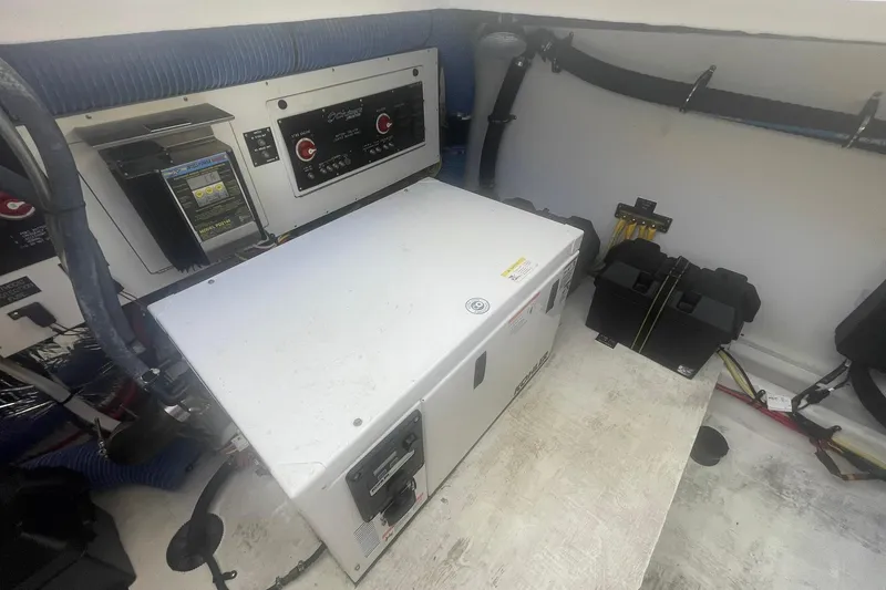 Slide: The Image of Engine room of 2014 Cruisers Yachts 380 Express with electrical components and generator. - 14