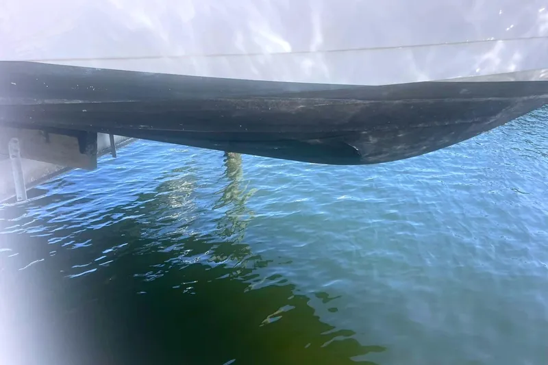 Slide: The Image of 2014 Cruisers Yachts 380 Express hull above clear blue water. - 6