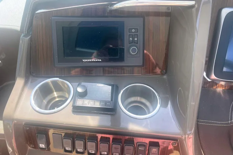 Slide: The Image of 2014 Cruisers Yachts 380 Express dashboard with Volvo Penta display and controls. - 15