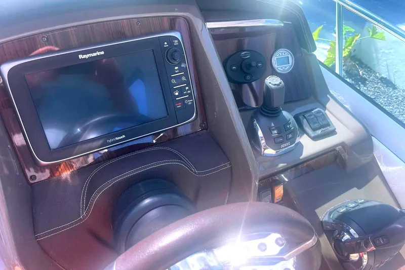 Slide: The Image of Control panel of 2014 Cruisers Yachts 380 Express with Raymarine display and joystick controls. - 16