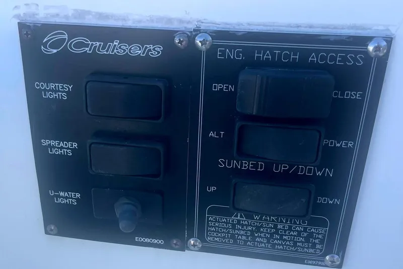 Slide: The Image of Control panel on a 2014 Cruisers Yachts 380 Express, featuring light and hatch switches. - 9