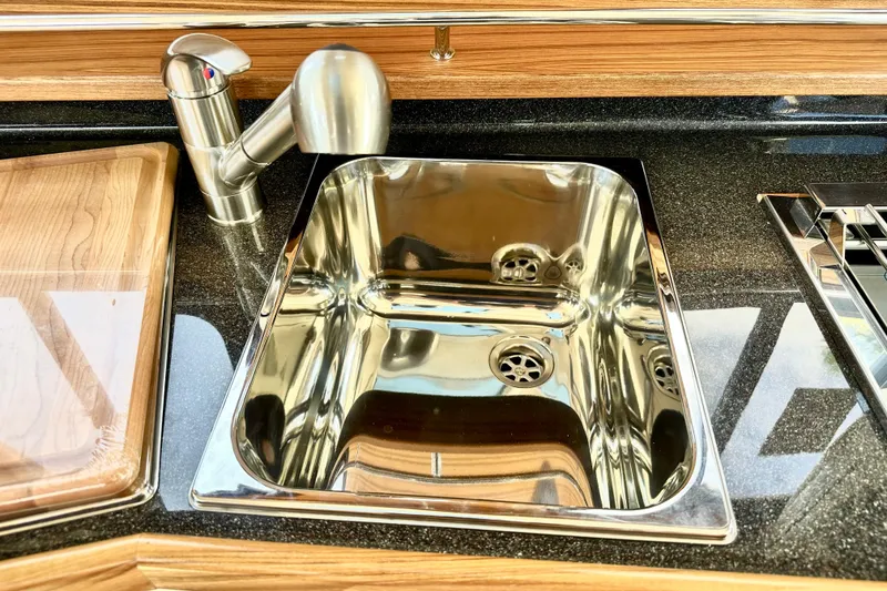 Slide: The Image of Stainless steel sink and faucet in 2026 Ranger Tugs R-31 CB kitchen area. - 14