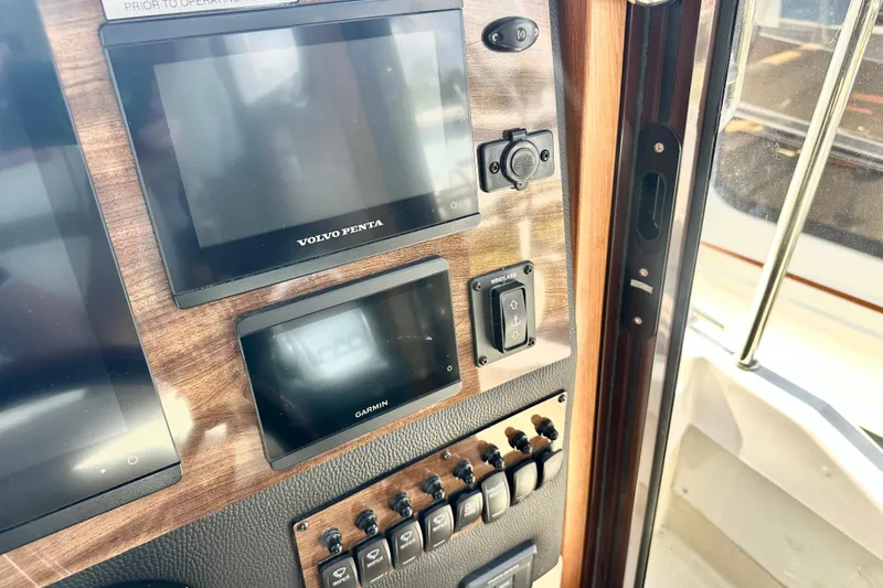 Slide: The Image of Control panel of 2026 Ranger Tugs R-31 CB with Volvo Penta and Garmin displays. - 23