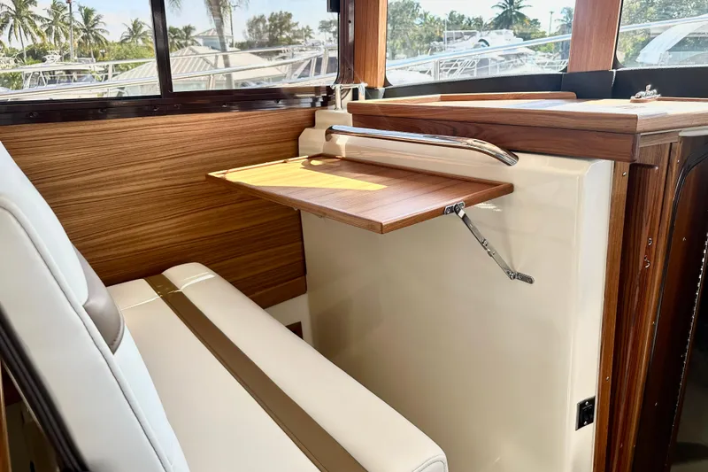 Slide: The Image of Interior of 2026 Ranger Tugs R-31 CB with wood accents and seating. - 25