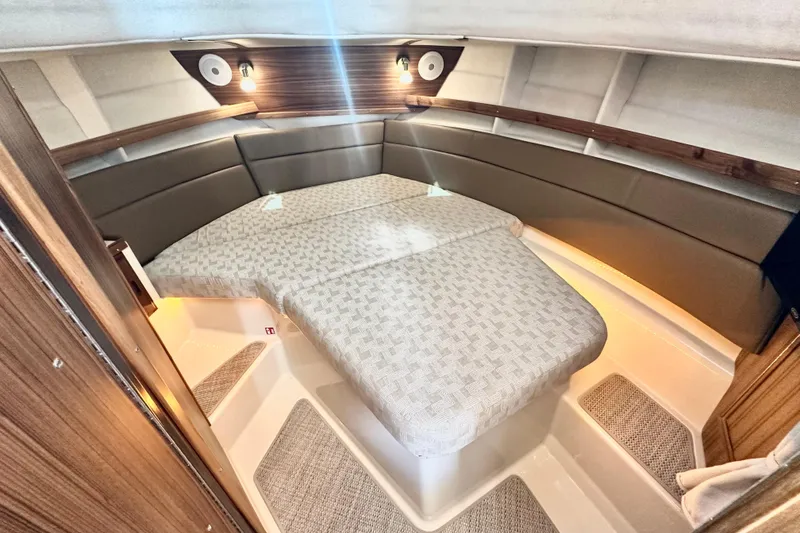 Slide: The Image of Interior cabin of 2026 Ranger Tugs R-31 CB with cozy bed and ambient lighting. - 26