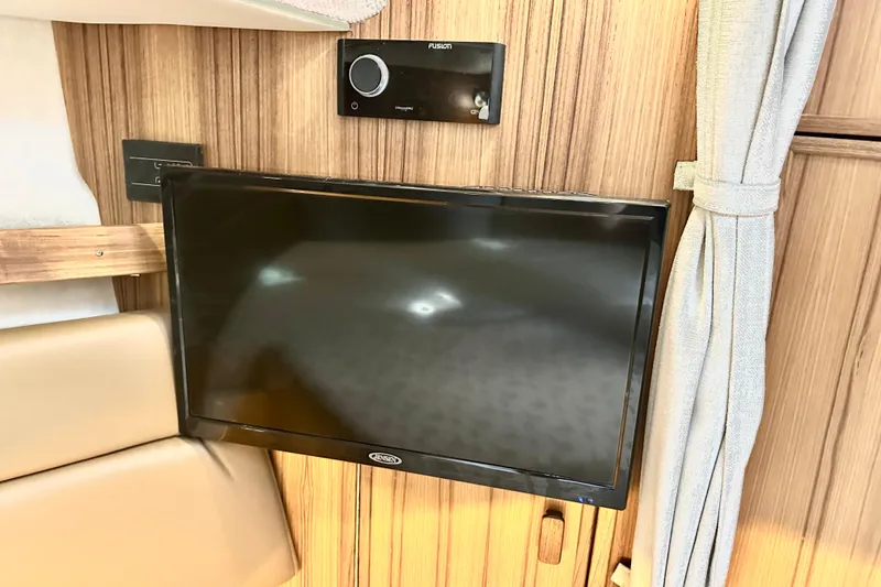 Slide: The Image of Interior of 2026 Ranger Tugs R-31 CB with mounted TV and audio system. - 27