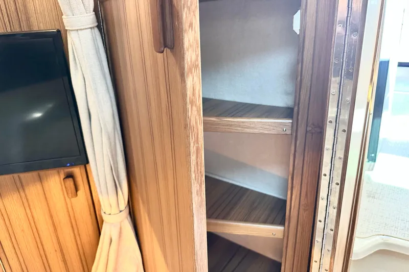 Slide: The Image of Interior of 2026 Ranger Tugs R-31 CB with wooden cabinetry and shelving. - 28