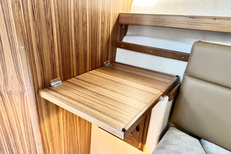 Slide: The Image of 2026 Ranger Tugs R-31 CB interior with foldable wooden table and seating. - 30