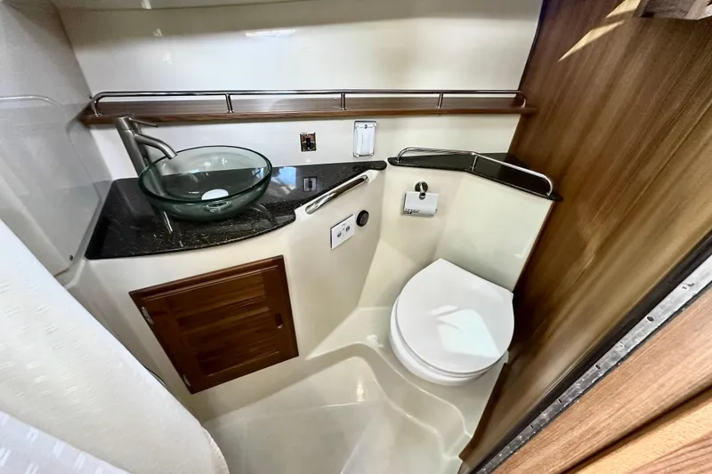 Slide: The Image of Bathroom interior of 2026 Ranger Tugs R-31 CB with modern fixtures and wood accents. - 31
