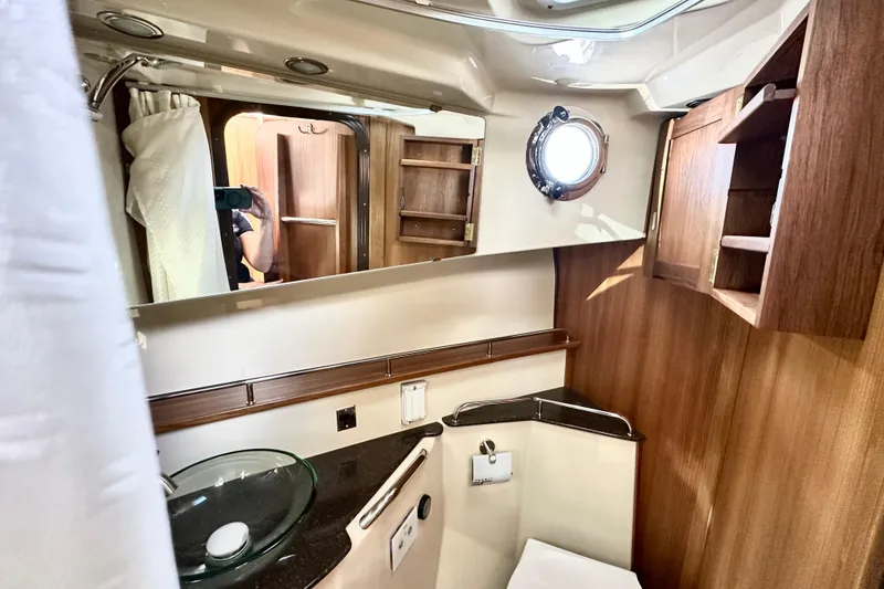 Slide: The Image of Luxurious bathroom interior of 2026 Ranger Tugs R-31 CB with wood accents and modern fixtures. - 32
