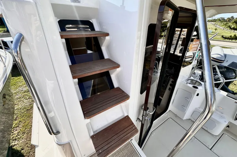 Slide: The Image of Staircase and entrance of 2026 Ranger Tugs R-31 CB boat, featuring wooden steps. - 37