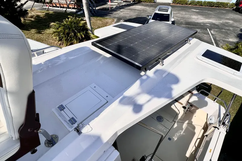 Slide: The Image of 2026 Ranger Tugs R-31 CB boat with solar panel on deck, parked outdoors. - 39