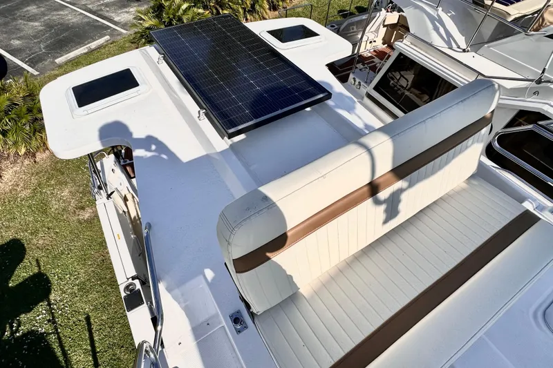 Slide: The Image of Ranger Tugs R-31 CB 2026 boat with solar panel and cushioned seating on deck. - 41