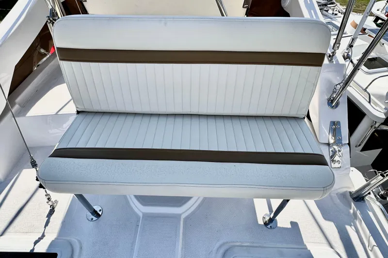 Slide: The Image of 2026 Ranger Tugs R-31 CB boat seat with white and brown upholstery. - 42